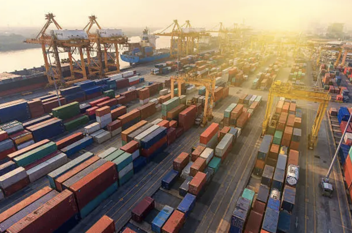 Aerial view of a global shipping port at sunset